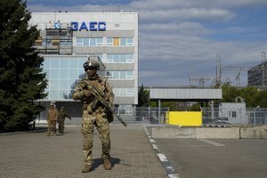 A Russian serviceman stands guard in an area of the Zaporizhzhia Nuclear Power Station in territory under Russian military control, southeastern Ukraine, on May 1, 2022