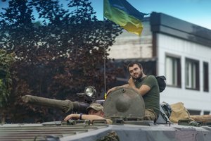 Ukrainian servicemen ride in a tank on a street in the Donetsk region, eastern Ukraine, Sunday, Aug. 14, 2022