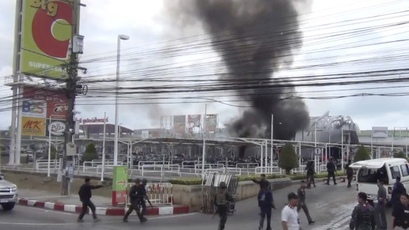 Smoke rises from an exploded vehicle outside a popular shopping center in Pattani province, southern Thailand, in 2017. The area has experienced a decades-long insurgency.