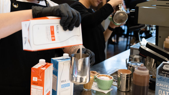 Barista Nando Lim from Bar Lume pours MILKLAB milk to make coffee.