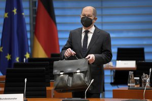 German Chancellor Olaf Scholz, arrives for a one day closed meeting of the German government at the Chancellery in Berlin, Germany, Friday, Jan. 21, 2022.