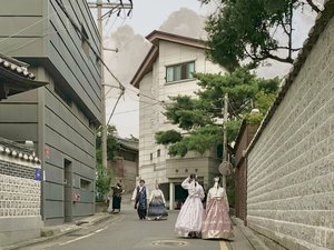 Visitors wearing rented Hanbok, strolling along Bukchon Hanok Village in Seoul, South Korea. Taken on August 2019.