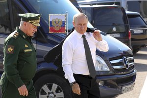 Russia's President Vladimir Putin and Russian Defense Minister Sergei Shoigu arrive to attend the opening of the Army 2022 International Military and Technical Forum in the Patriot Park outside Moscow, Russia, Monday, Aug. 15, 2022