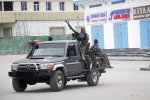 Soldiers patrol outside the Hayat Hotel in Mogadishu, Somalia, Saturday Aug, 20, 2022. At least 13 people were killed in an attack by Islamic militants who stormed the hotel in Somalia's capital late Friday, police and eyewitnesses said.