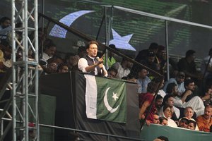 Pakistani opposition leader Imran Khan, center, addresses his party supporters during a rally to press government for fresh elections, in Lahore, Pakistan, Saturday, Aug. 13, 2022.