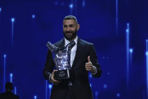 Real Madrid's Karim Benzema holds his trophy as Men's player of the year during the soccer Champions League draw ceremony in Istanbul, Turkey, Thursday, Aug. 25, 2022