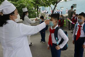 Kim Song Ju Primary school students have their temperatures checked before entering the school in Pyongyang, North Korea, Wednesday, June 3, 2020. All the schools in the country start their lessons this month after delays over concern about the new coronavirus.