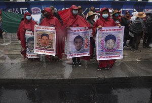 Family members and friends march seeking justice for the missing 43 Ayotzinapa students in Mexico City, Friday, Aug. 26, 2022