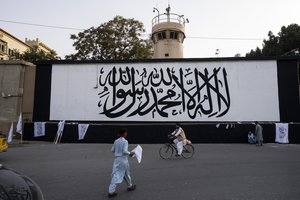 File - The iconic Taliban flag is painted on a wall outside the American embassy compound in Kabul, Afghanistan, Saturday, Sept. 11, 2021.