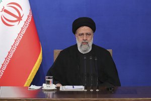 In this photo released by the official website of the office of the Iranian Presidency, President Ebrahim Raisi sits during his press conference in Tehran, Iran, Monday, Aug. 29, 2022