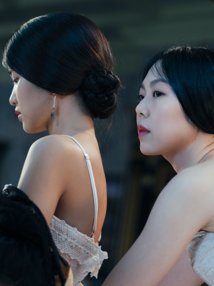 Lesbian Period Drama A still from the film “The Handmaiden” showing two women  in white clothing looking off to the left.