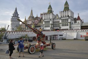 People walk at the Izmailovsky Kremlin in Moscow, Russia, Sunday, Aug. 21, 2022