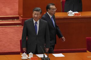 Chinese President Xi Jinping, left, and his Premier Li Keqiang arrive at an event commemorating the 110th anniversary of Xinhai Revolution at the Great Hall of the People in Beijing, Saturday, Oct. 9, 2021