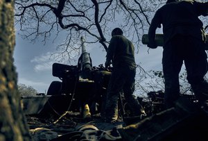 Ukrainian soldiers fire, on the front line in the Donetsk region, eastern Ukraine, Sat. Sept. 3, 2022.