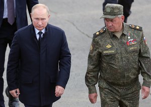 FILE - Russian President Vladimir Putin, left, and Russian Defense Minister Sergei Shoigu arrive to attend the joint strategic exercise of the armed forces of the Russian Federation and the Republic of Belarus Zapad-2021 at the Mulino training ground in the Nizhny Novgorod region, Russia, on Sept. 13, 2021