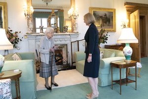 Britain's Queen Elizabeth II, left, welcomes Liz Truss during an audience at Balmoral, Scotland, where she invited the newly elected leader of the Conservative party to become Prime Minister and form a new government, Tuesday, Sept. 6, 2022.