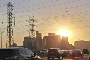 Vehicles travel near high power transmission towers in downtown Los Angeles, Tuesday, Sept. 6, 2022. As California stretched into its second week of excessive heat, the California Independent System Operator, the entity that oversees the state's electrical grid, issued a Stage 3 alert allowing it to draw on emergency power sources.