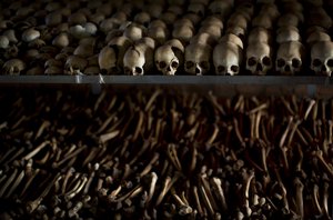 FILE - In this Friday, April 4, 2014 file photo, the skulls and bones of some of those who were slaughtered as they sought refuge inside the church, are laid out on shelves in an underground vault as a memorial to the thousands who were killed in and around the Catholic church during the 1994 genocide in Nyamata, Rwanda.