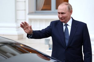 Russian President Vladimir Putin waves Turkish President Recep Tayyip Erdogan as he leaves after their talks at the Rus sanatorium in the Black Sea resort of Sochi, Russia, Friday, Aug. 5, 2022