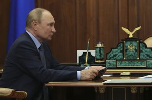 Russian President Vladimir Putin meets with the newly appointed Aeroflot air company chairman and CEO Sergei Aleksandrovsky, in the Kremlin, in Moscow, Russia, Friday, Aug. 26, 2022