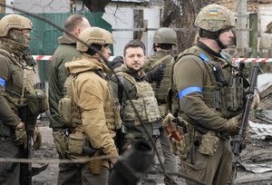 Ukrainian President Volodymyr Zelenskyy examines the site of a recent battle in Bucha, close to Kyiv, Ukraine, Monday, Apr. 4, 2022. Russia is facing a fresh wave of condemnation after evidence emerged of what appeared to be deliberate killings of civilians in Ukraine.