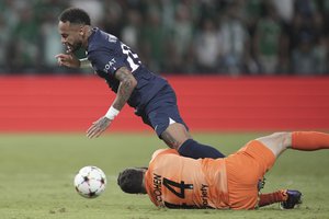 Maccabi Haifa's goalkeeper Josh Cohen, right, vies for the ball with PSG's Neymar during the group H Champions League soccer match between Maccabi Haifa and Paris Saint-Germain in Haifa, Israel, Wednesday, Sept. 14, 2022