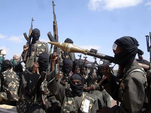 FILE - In this Dec. 8, 2008 file photo, armed al-Shabab fighters on pickup trucks prepare to travel into the city, just outside Mogadishu, in Somalia.