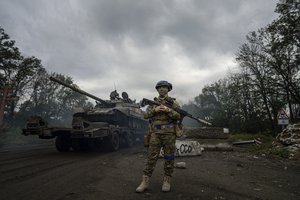 A Ukrainian serviceman stands at the checkpoint near the recently retaken area of Izium, Ukraine, Thursday, Sept. 15, 2022