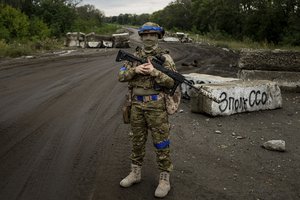 A Ukrainian serviceman stands at the checkpoint near the recently retaken area of Izium, Ukraine, Thursday, Sept. 15, 2022