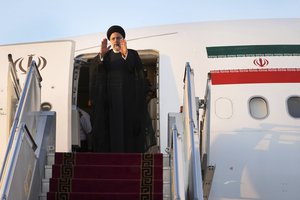 Iranian President Ebrahim Raisi waves to media and officials as he boards his plane while leaving Tehran's Mehrabad airport to New York to attend annual UN General Assembly meeting, Monday, Sept. 19, 2022