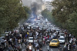 In this Wednesday, Sept. 21, 2022, photo taken by an individual not employed by the Associated Press and obtained by the AP outside Iran, protesters chant slogans during a protest over the death of a woman who was detained by the morality police, in downtown Tehran, Iran.