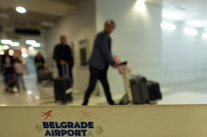 Passengers pass through the airport building in Belgrade, Serbia, Wednesday, Sept. 21, 2022.