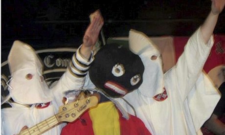 Video still showing Klu Klux Klan costumes and golliwog