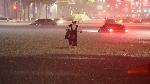 A man makes his way through flooded area during heavy rain in Seoul, South Korea, August 8, 2022.    Yonhap via REUTERS   