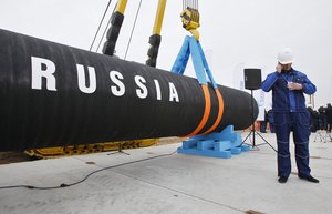 FILE In this Friday, April 9, 2010 file photo a Russian construction worker speaks on a mobile phone in Portovaya Bay some 170 kms (106 miles) north-west from St. Petersburg, Russia, during a ceremony marking the start of Nord Stream pipeline construction.