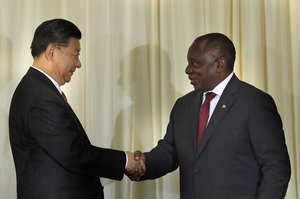 South African President Cyril Ramaphosa, right, shakes hand with Chinese President Xi Jinping after a joint press conference at the government's Union Buildings in Pretoria, South Africa