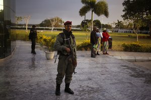 A Mozambican soldier provide security before the arrival of India's Prime Minister Narendra Modi at a technical school in Maluana, Mozambique, Thursday, July 7, 2016