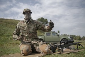 Ukrainian sniper Andriy speaks to The Associated Press during a training outside of Kyiv, Ukraine, Saturday, Aug. 27, 2022