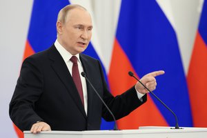 Russian President Vladimir Putin gestures during a ceremony to sign the treaties for four regions of Ukraine to join Russia, at the Kremlin in Moscow, Russia, Friday, Sept. 30, 2022