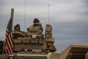 American soldiers sit in a fighting vehicle near prison that was attacked by the Islamic Stete militants in Hassakeh, Syria, Tuesday, Feb. 8, 2022