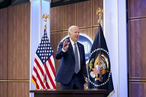 President Joe Biden waves after speaking virtually at the Summit on Fire Prevention and Control from the South Court Auditorium on the White House complex in Washington, Tuesday, Oct. 11, 2022.