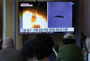 A TV screen shows file images of North Korea's missile launch during a news program at the Seoul Railway Station in Seoul, South Korea, Thursday, Oct. 13, 2022