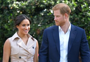 In this Oct. 2, 2019, file photo, Britain's Prince Harry and Meghan Markle appear at the Creative Industries and Business Reception at the British High Commissioner's residence in Johannesburg.