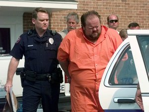 Officials escort murder suspect Alan Eugene Miller away from the Pelham City Jail in Alabama, Aug. 5, 1999