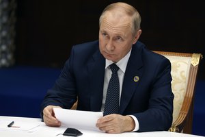 Russian President Vladimir Putin listens to Azerbaijan's President Ilham Aliyev during their meeting on sidelines of the Conference on Interaction and Confidence Building Measures in Asia (CICA) summit, in Astana, Kazakhstan, Thursday, Oct. 13, 2022