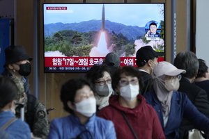 A TV screen shows a file image of North Korea's missile launch during a news program at the Seoul Railway Station in Seoul, South Korea, Friday, Oct. 14, 2022