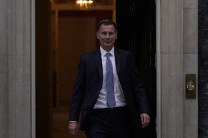 Britain's new Treasury Chief Jeremy Hunt leaves 10 Downing Street after meeting the Prime Minister Liz Trus, in London, Friday, Oct. 14, 2022