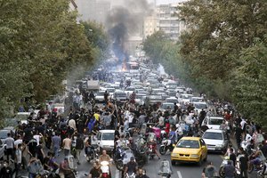 In this photo taken by an individual not employed by the Associated Press and obtained by the AP outside Iran, protesters chant slogans during a protest over the death of a woman who was detained by the morality police, in downtown Tehran, Iran, Sept. 21, 2022