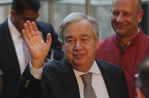 UN Secretary General Antonio Guterres waves to media as he arrives for the inauguration of UN house in New Delhi, India, Monday, Oct. 1, 2018.