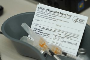 Syringes with Pfizer COVID-19 vaccine shots for children aged 6 months to 4 years old are shown next to vaccine cards, Tuesday, June 21, 2022, at a University of Washington Medical Center clinic in Seattle